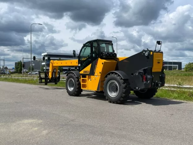 Yellow Dieci telescopic handler parked on an industrial street with overcast sky in the background.