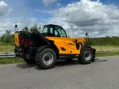 Yellow Dieci Hercules 190.10 telehandler on a road, with a cloudy sky background and grassy fields on both sides.