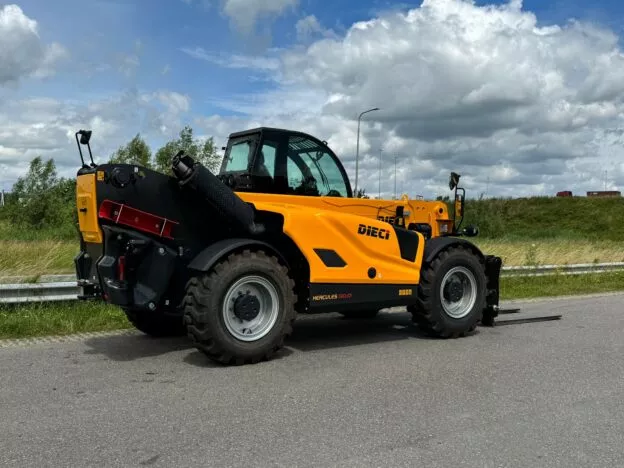 Yellow Dieci Hercules 190.10 telehandler on a road, with a cloudy sky background and grassy fields on both sides.