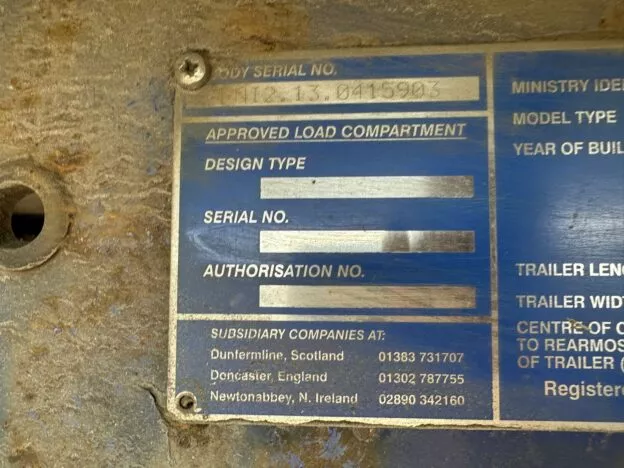 Metal ID plate with serial numbers and company info for Dunfermline, Doncaster, and Newtonabbey. Blue with white text.